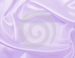 Smooth elegant lilac silk or satin texture as wedding background. Luxurious background design