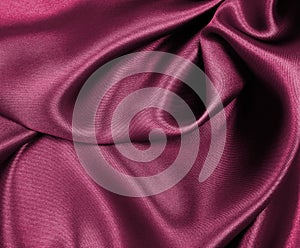 Smooth elegant pink silk or satin luxury cloth texture as abstract background. Luxurious background design