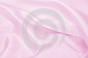 Smooth elegant pink silk or satin texture as wedding background. Luxurious background design