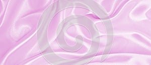 Smooth elegant pink silk or satin texture as wedding background. Luxurious background design