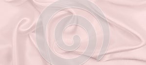 Smooth elegant pink silk or satin texture as wedding background. Luxurious background design