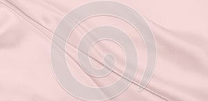 Smooth elegant pink silk or satin texture as wedding background. Luxurious background design