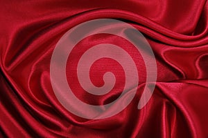 Smooth elegant red silk or satin luxury cloth texture as abstract background. Luxurious valentines day background design