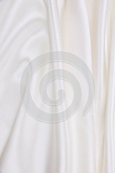 Smooth elegant white silk or satin luxury cloth texture as wedding background. Luxurious background design