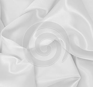 Smooth elegant white silk or satin luxury cloth texture as wedding background. Luxurious background design