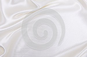 Smooth elegant white silk or satin luxury cloth texture as wedding background. Luxurious Christmas background or New Year