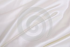 Smooth elegant white silk or satin luxury cloth texture as wedding background. Luxurious Christmas background or New Year