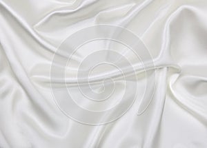 Smooth elegant white silk or satin luxury cloth texture as wedding background. Luxurious Christmas background or New Year