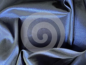 Smooth Elelgant Folds of Dark Blue Satin Fabric Define a Space for Copy. Can be used as a Background.