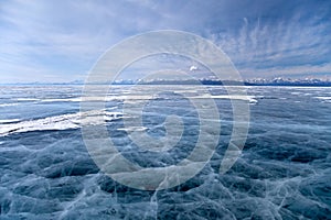 Smooth ice surface with cracks net of winter frozen lake Hovsgol in Mongolia