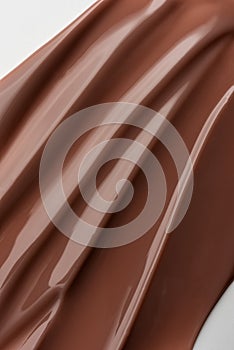 Smooth melted chocolate texture with soft light reflections