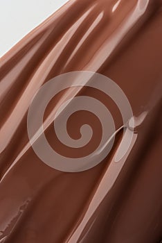 Smooth melted chocolate texture with soft light reflections