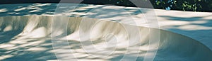 Smooth microcement surface with subtle texture variations in a bright setting photo