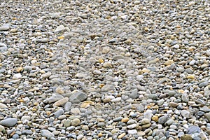 Smooth round pebbles sea texture background. Pebble on a beach.