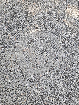 Smooth round pebbles texture background. Pebble sea beach close-up, dark wet pebble and gray dry pebble