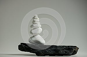 smooth stones balanced over one black