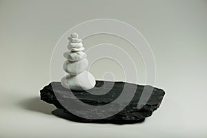 smooth stones balanced over one black