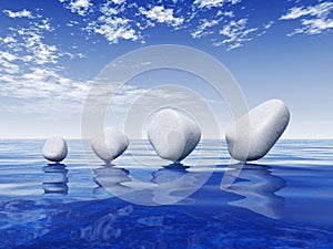 Smooth stones balanced on water