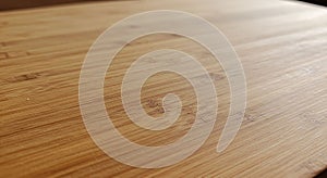Smooth wooden surface with a light bamboo texture, featuring subtle linear grain