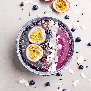 Smoothie acai bowl served in bowl on grey table