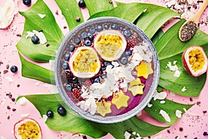 Smoothie acai bowl served in bowl on pink table