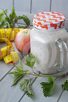 Smoothie with apples, bananas, nettle. Organic diet, healthy lifestyle concept. Tape mesure