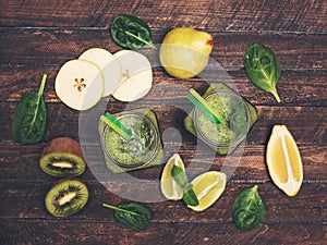 Smoothie with avocado, spinach, lime, kiwi, and pear in a jar