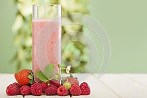 Smoothie of berries on the table in garden