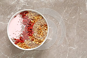 Smoothie bowl with goji berries on beige marble table