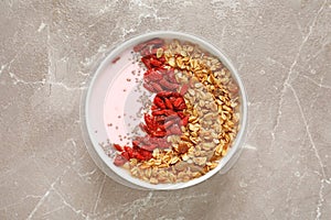 Smoothie bowl with goji berries on beige marble table