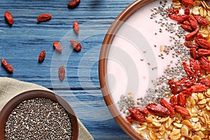 Smoothie bowl with goji berries on blue wooden table