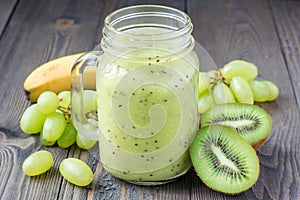 Smoothie with kiwi, green grape, and banana in glass jar, horizontal