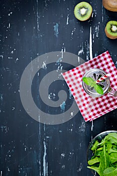 Smoothie with kiwi and spinach. Top view. Food background