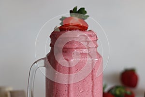 Smoothie made of fresh strawberries, banana and almond milk