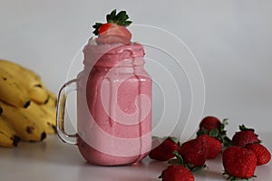 Smoothie made of fresh strawberries, banana and almond milk