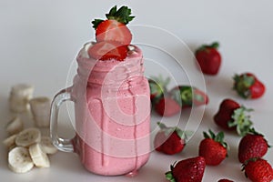 Smoothie made of fresh strawberries, banana and almond milk