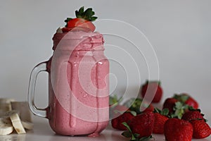 Smoothie made of fresh strawberries, banana and almond milk