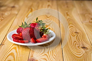 Smoothie with strawberry in bottles on wooden table