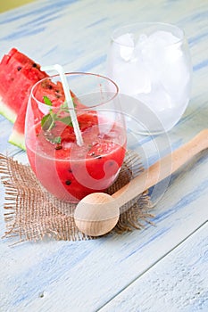 Smoothie from water melon on burlap with wooden pestle