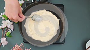 Smoothing with a spoon of egg foam in a pan