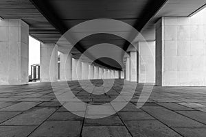 A smoothly curved gallery with rectangular vertical light columns of stone.