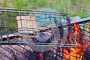 Smored being grilled over an open flame