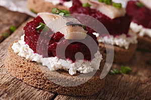 smorrebrod with herring, beetroot and cheese close-up. horizontal photo