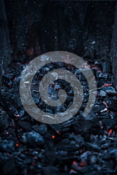 Smouldering coals at barbeque campfire