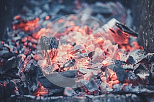 Smouldering coals at barbeque campfire