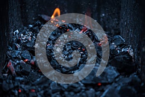 Smouldering coals at barbeque campfire