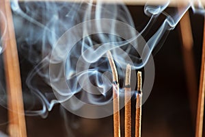 Smouldering incense sticks, burning and smoking