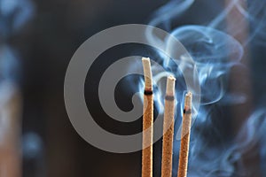 Smouldering incense sticks, burning and smoking
