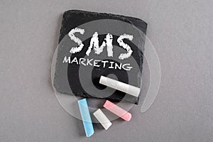 SMS MARKETING. Business concept. Text on a stone surface