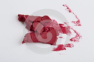 Smudged red lipstick on white background